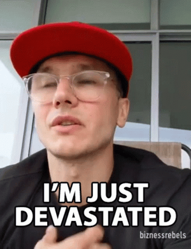 Man in Glasses and Red Hat Saying I'm Just Devastated