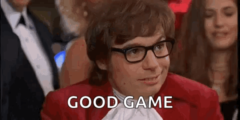 Man in Glasses and Red Jacket Saying Good Game in Crowd