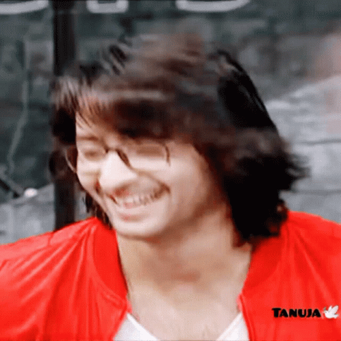 Man in Glasses and Red Jacket With Tanuja