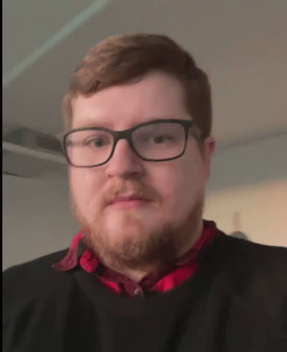 Man in Glasses and Red Shirt Processing