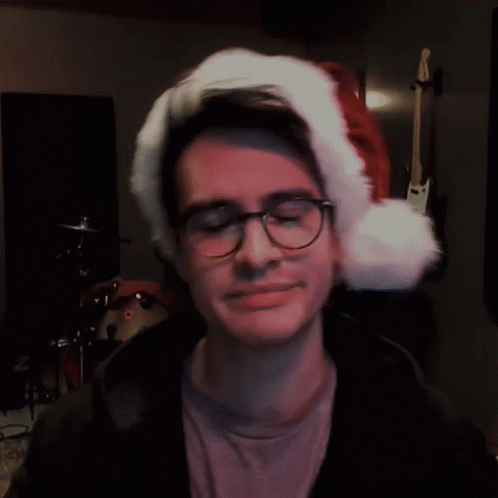 Man in Glasses and Santa Hat Looking Sideways