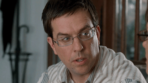 Man in Glasses and Striped Shirt Talking to Another Man