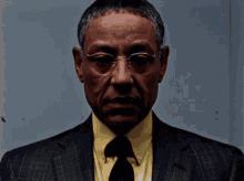 Man In Glasses And Suit Looking At Camera GIF