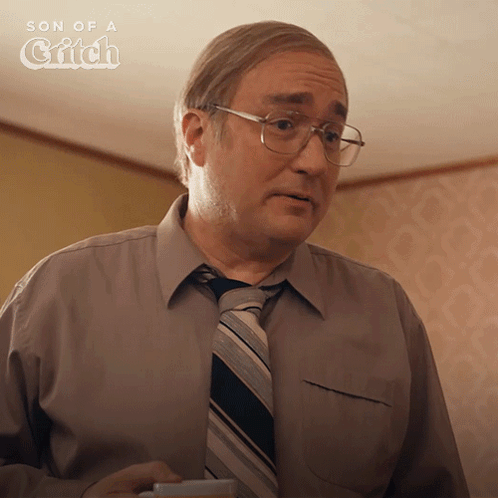 Man In Glasses And Tie Holding Coffee With Son Of A Critch Sign GIF
