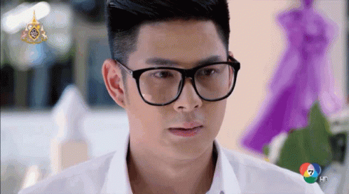 Man in Glasses and White Shirt Looking at Camera