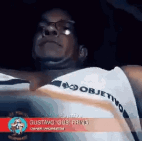 Man In Glasses And White Shirt With Objetivo On Sleeve GIF