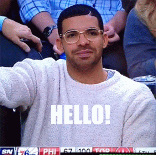 Man in Glasses and White Sweater Saying Hello