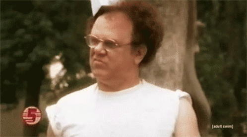 Man in Glasses and White Tank Top Beside Tree