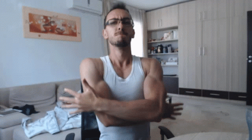 Man In Glasses And White Tank Top With Arms Crossed GIF