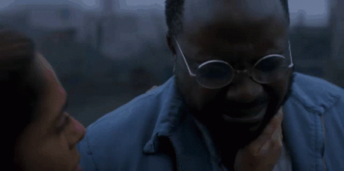 Man in Glasses Comforted by Woman in Blue Jacket