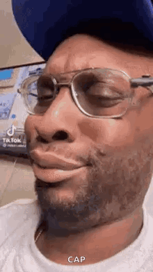 Man In Glasses, Hat, White Shirt Making Funny Face GIF