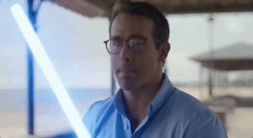 Man in Glasses Holding Light Saber