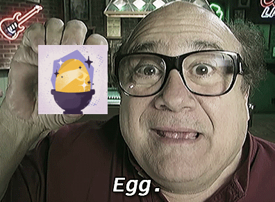 Man in Glasses Holding Picture of Egg With Word Egg