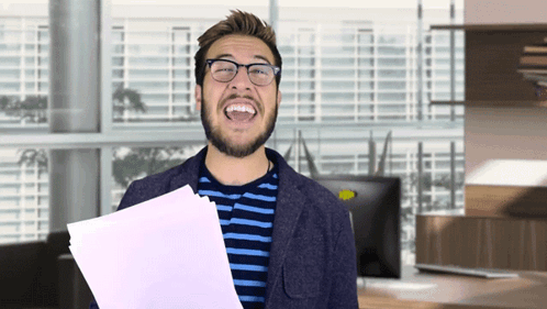 Man in Glasses Laughing Holding Paper