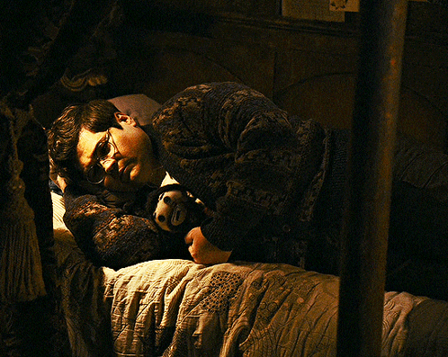 Man in Glasses Lying on Bed With Stuffed Animal