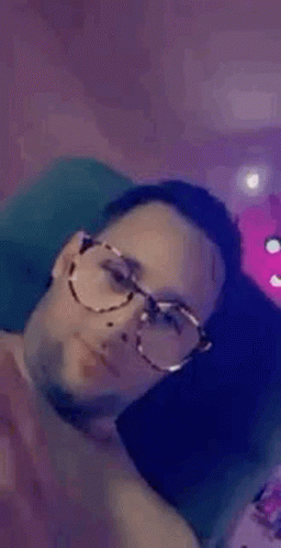 Man in Glasses on Couch Smiling