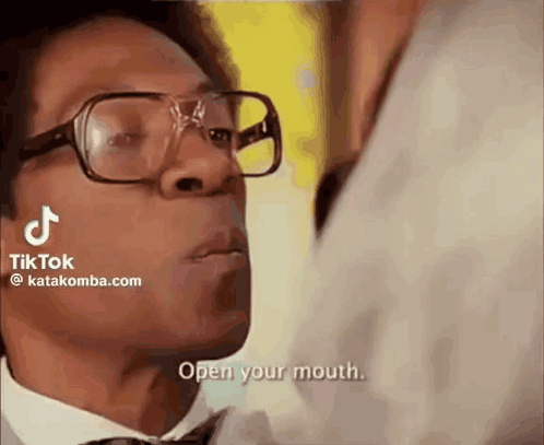 Man in Glasses Telling Open Your Mouth