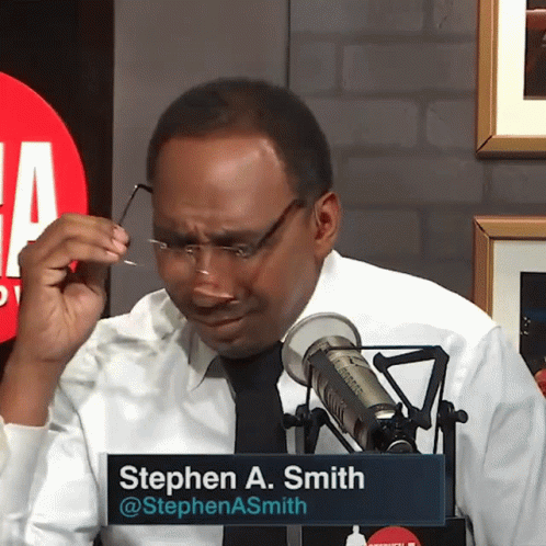Man in Glasses with Stephen A. Smith Name Tag at Microphone