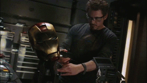 Man in Glasses Working on Iron Man Helmet