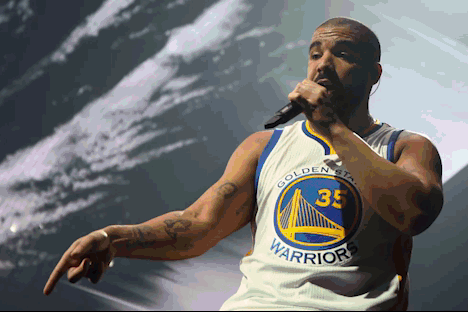 Man in Golden State Warriors Jersey Singing Microphone