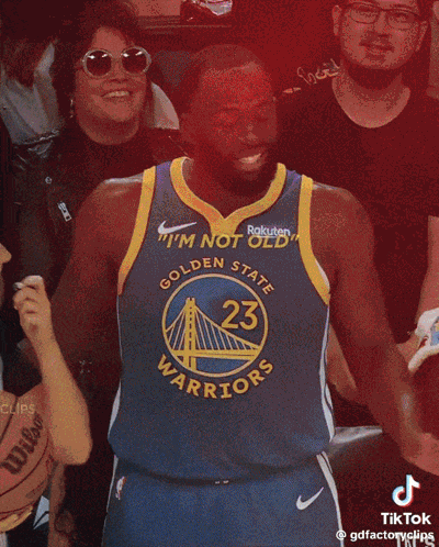 Man in Golden State Warriors Jersey Smiling Thumbs Up