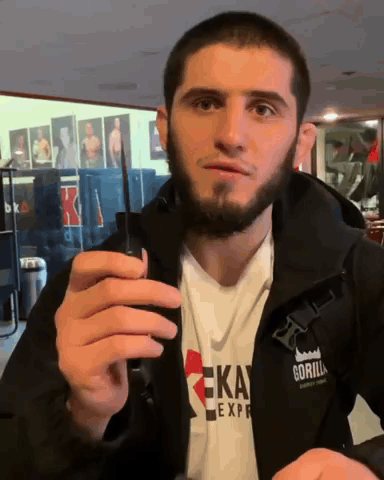 Man In Gorilla Express Jacket Holding Cell Phone GIF