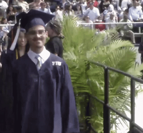 Man in Graduation Cap and Gown with FIU Shirt
