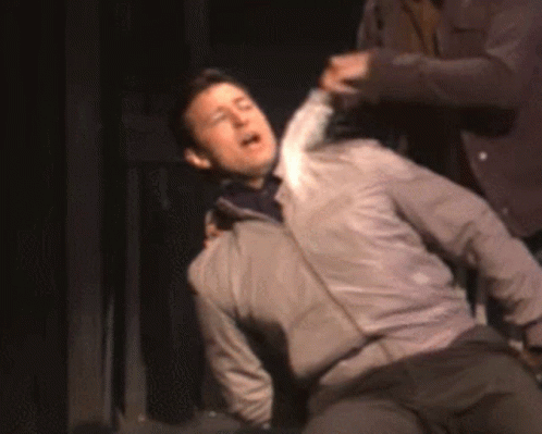 Man In Gray Jacket Lying On Floor GIF