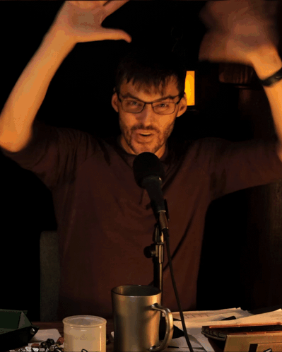 Man In Gray Shirt Held By Another Man's Hand GIF
