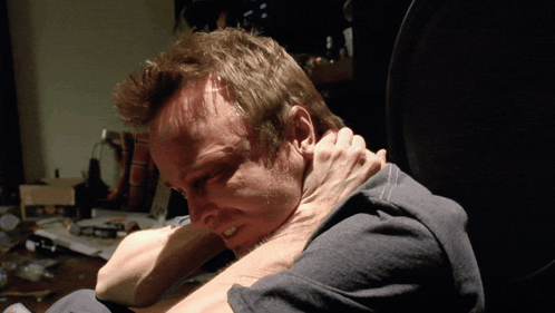 Man In Gray Shirt Held By Another Man's Hand GIF