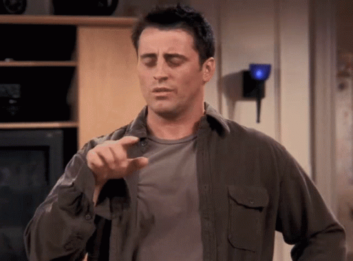 Man In Gray Shirt Pointing At Camera GIF
