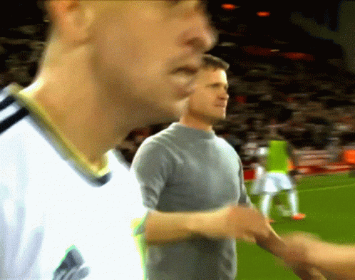 Man in Gray Shirt Shakes Hands With Man in White Shirt