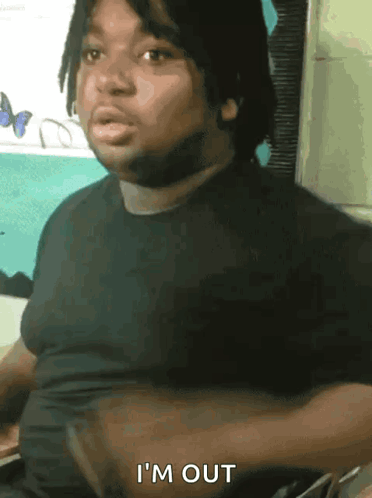 Man in Gray Shirt Sitting With Arms Crossed Says Yup