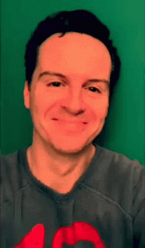 Man in Gray Shirt With Red Heart Smiling