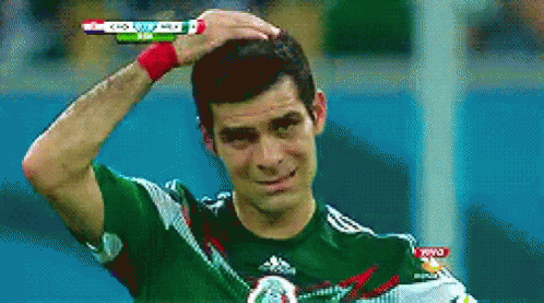 Man in Green Adidas Shirt Holding Head