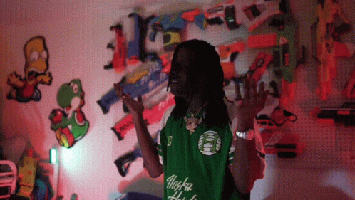 Man in Green Alaska Shirt by Nerf Guns
