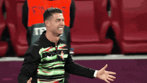 Man in Green and Black Shirt With Red T