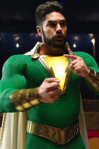 Man in Green and Gold Superhero Costume Holding Light