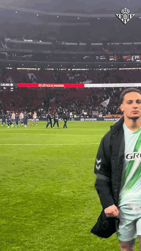 Man in Green and White Jersey Saying Gro on Soccer Field
