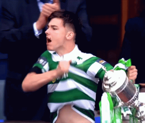 Man In Green And White Striped Shirt Holding Trophy GIF