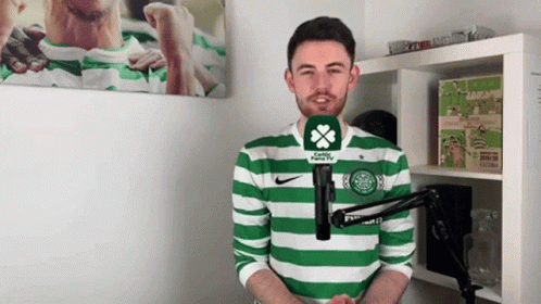 Man in Green and White Striped Shirt Talking