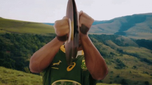 Man In Green And Yellow Asics Jersey Holding Plate GIF