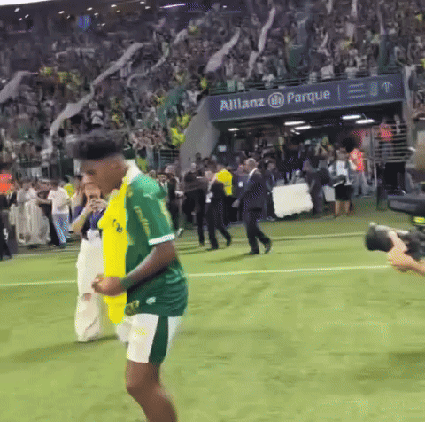 Man in Green and Yellow Jersey on Soccer Field with Allianz Sign