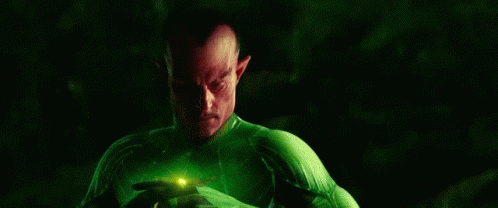 Man in Green and Yellow Superhero Costume Holding Green Object