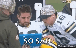 Man in Green Bay Packers Jersey Looking at Tablet