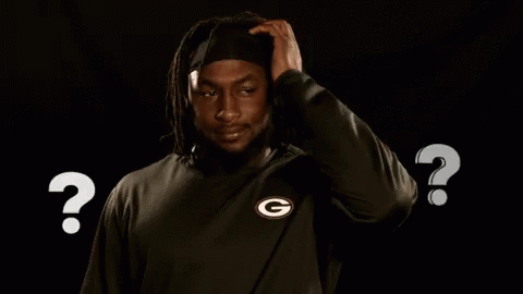 Man in Green Bay Packers Shirt Scratching Head