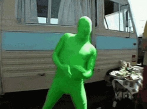 Man In Green Bodysuit Dancing By Camper Van GIF
