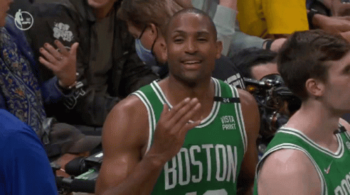 Man in Green Boston Jersey Applauding During Game