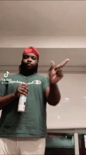 Man In Green Champion Shirt Holding Spray Can GIF
