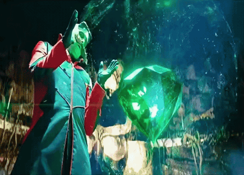 Man In Green Coat Holding Green Cube GIF